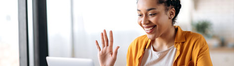 Woman waving on video communication